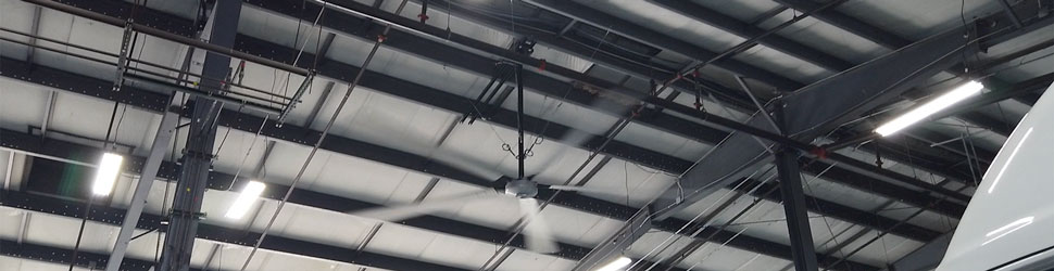 large industrial HVLS fan cooling down a warehouse