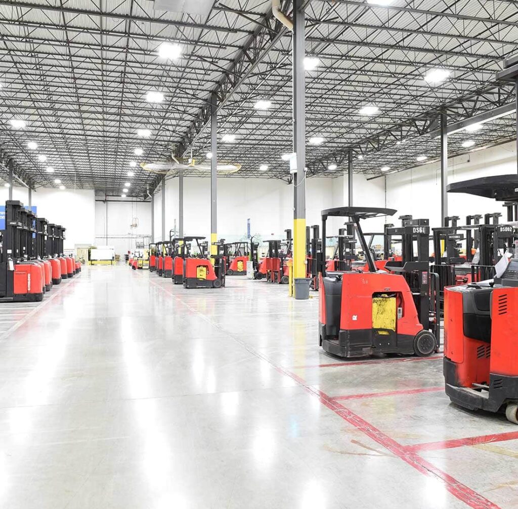 large warehouse with forklifts being parked and charging