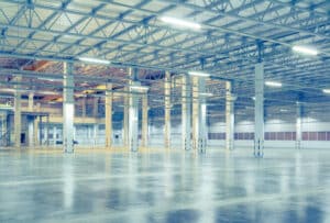 brightly lit empty industrial warehouse space