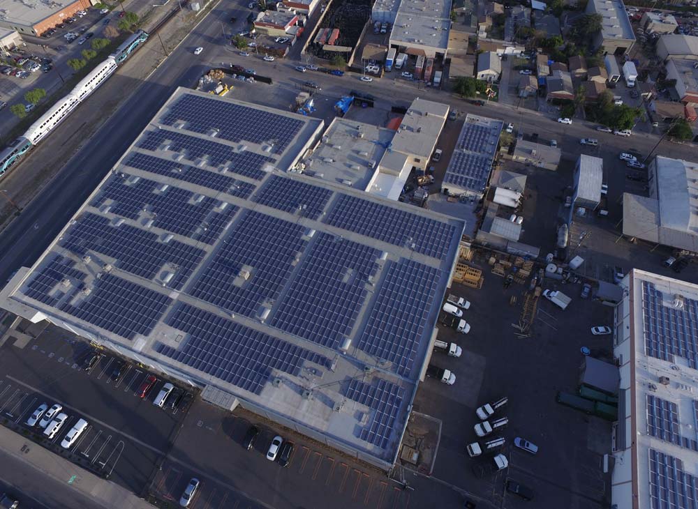 drone shot of rooftop solar systems of commercial buildings